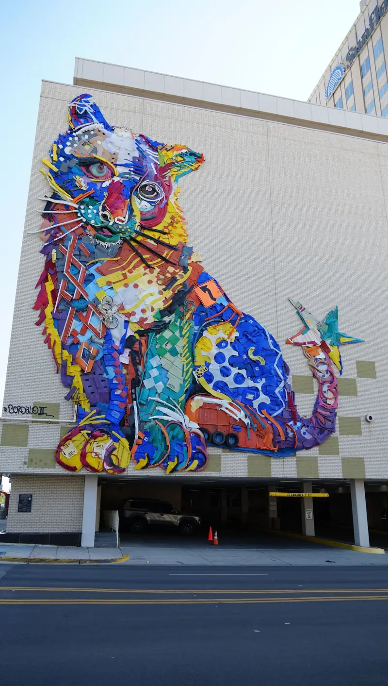Large colorful cat mural on the exterior of a downtown El Paso parking garage